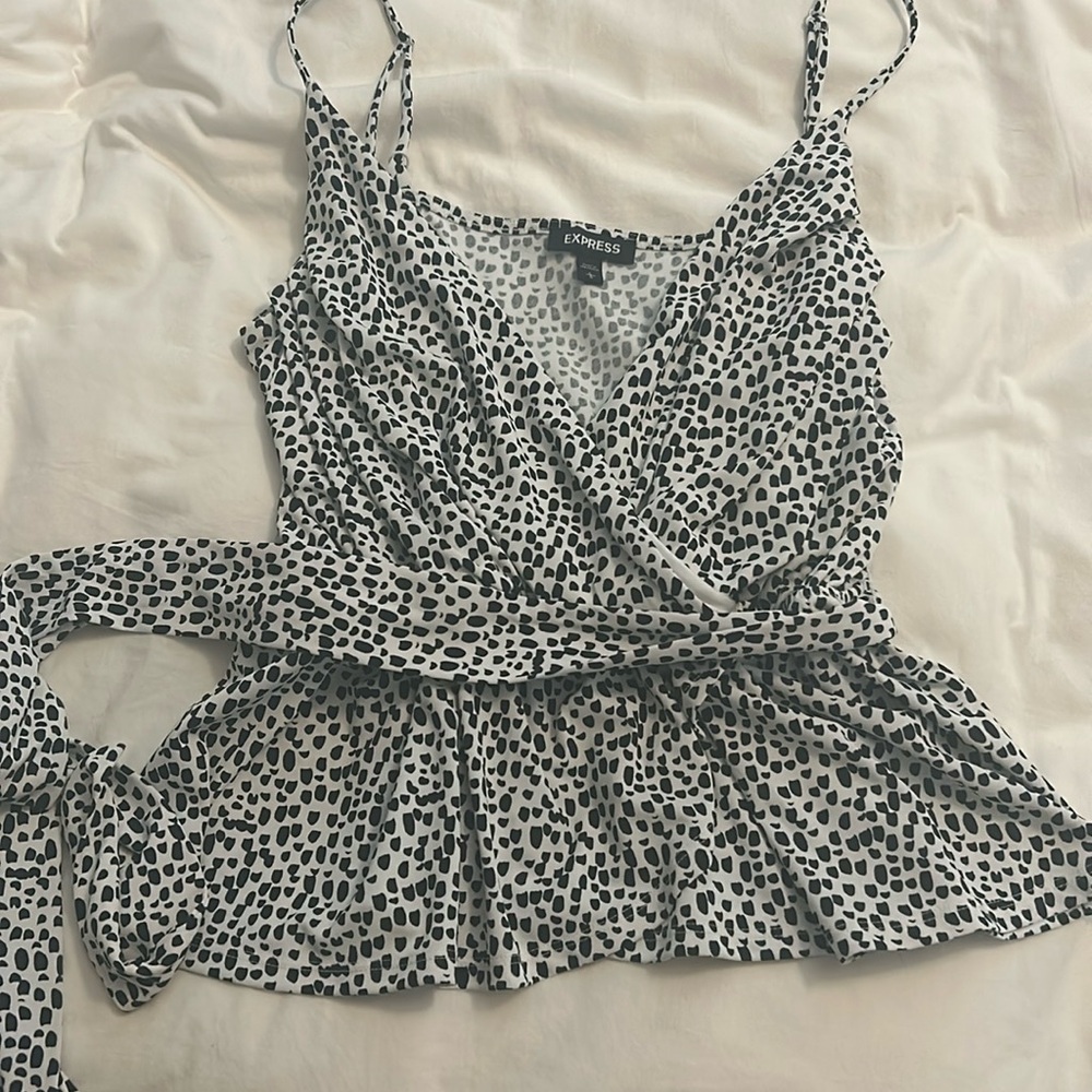 Express black and white silky blouse. Toes around the waist